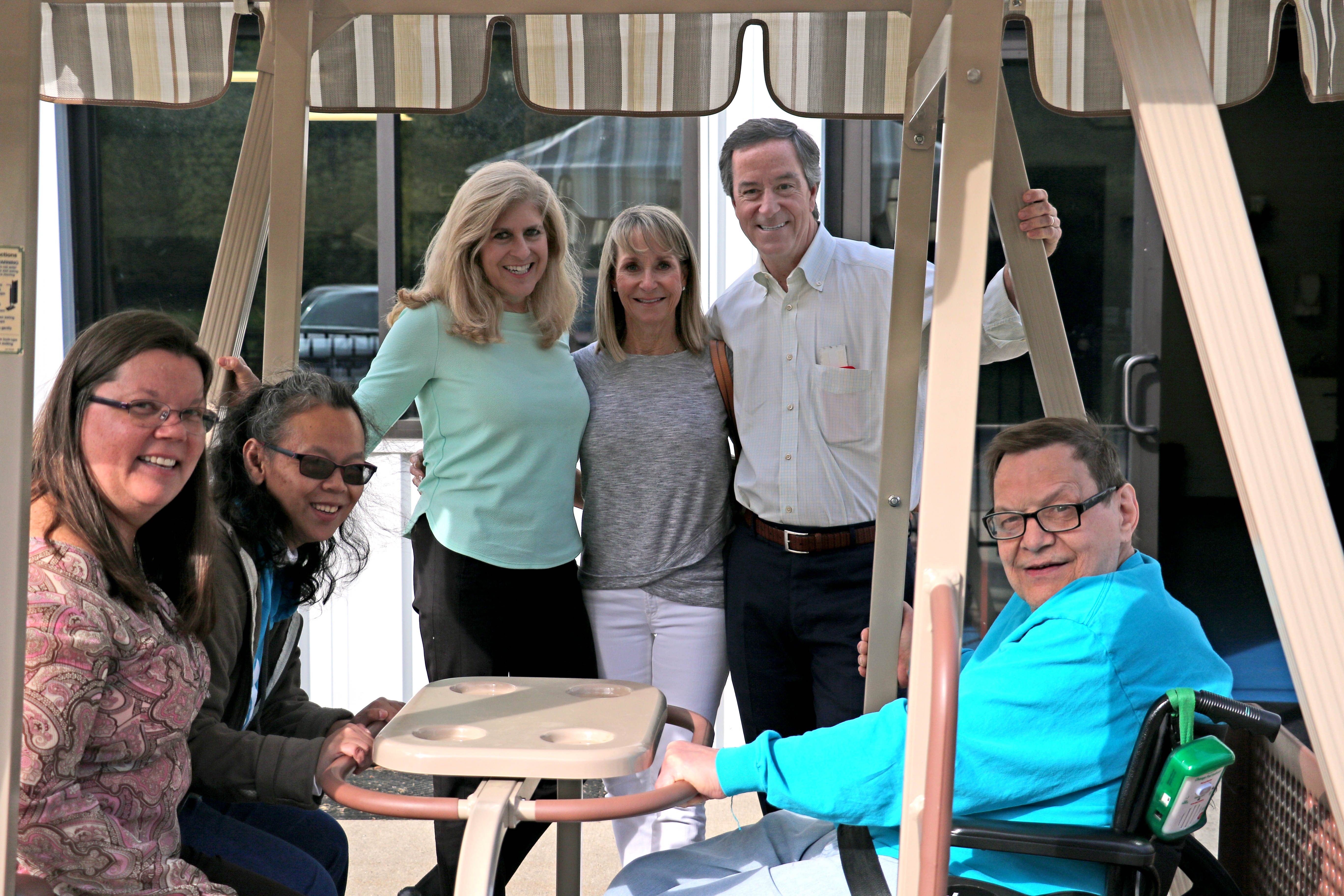 Donors of WhisperGLIDE visit ADEC to dedicate plaque on swing